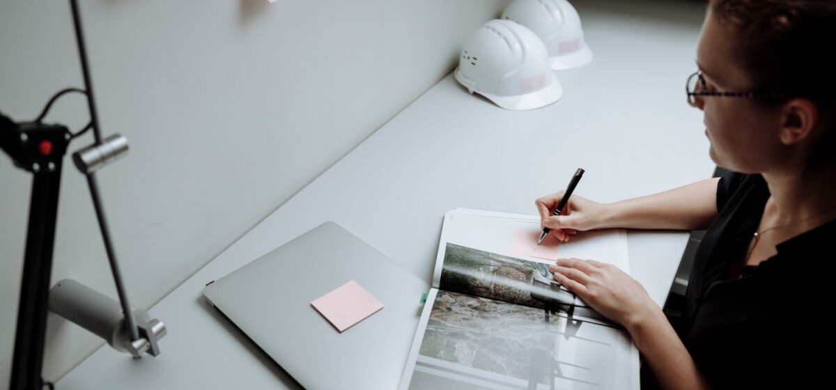 Engineer making technical notes at a desk