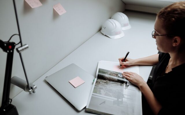 Engineer making technical notes at a desk
